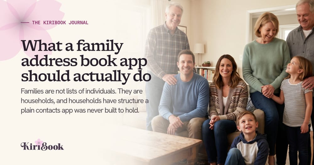 Three generations of a family gathered in a living room, grandparents standing behind a couple on the sofa with two young children