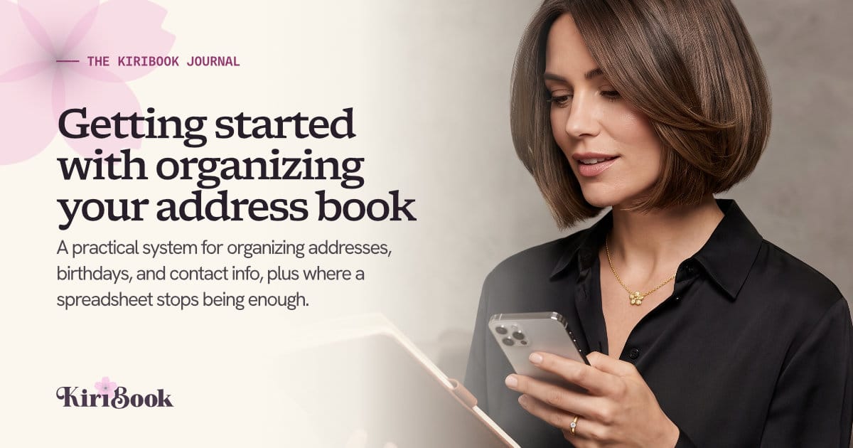 A woman checking contact details on her phone and comparing them to a leather address book